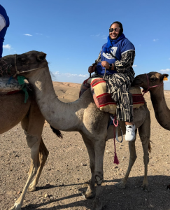 Desarae Nelson rides a camel in the Agafay Desert.